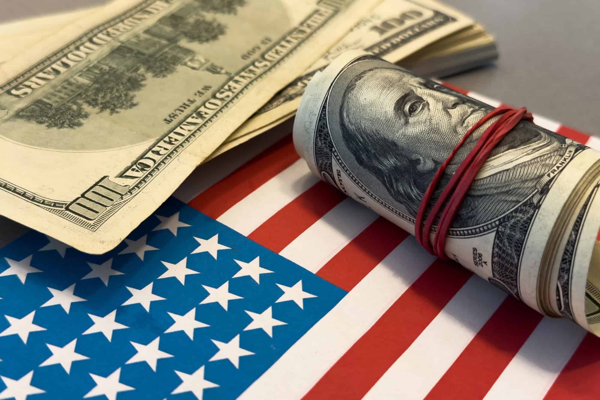 dollar money and American flag. bankrupt man counting money cash. business crisis finance dollar concept. close-up of a usd hand counting paper dollars. exchange finance economy dollar pay tax