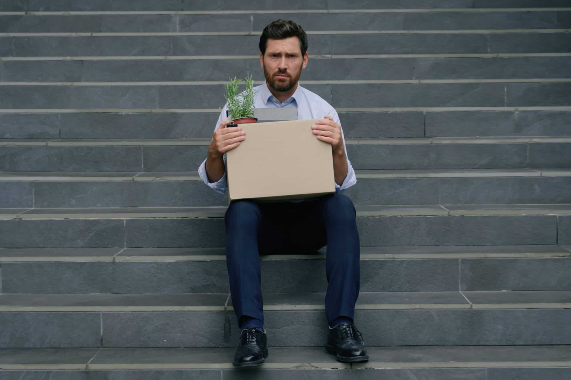 Portrait frustrated sad stressed bankrupt fired work job lost middle-aged Caucasian businessman adult man business guy male in city unemployment crisis holding dismissed box dismissal looking camera