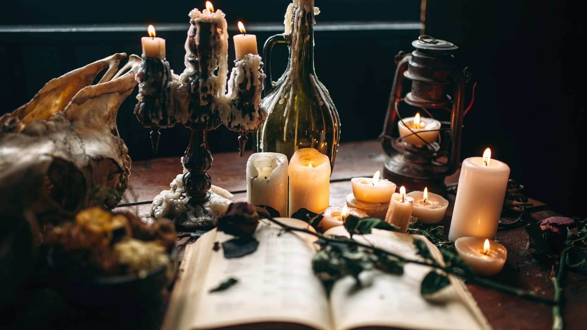 Witchcraft, dark magic, candles with ritual book
