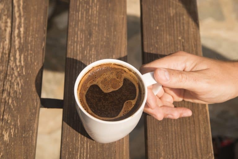 Close up white coffee cup on the table at morning time