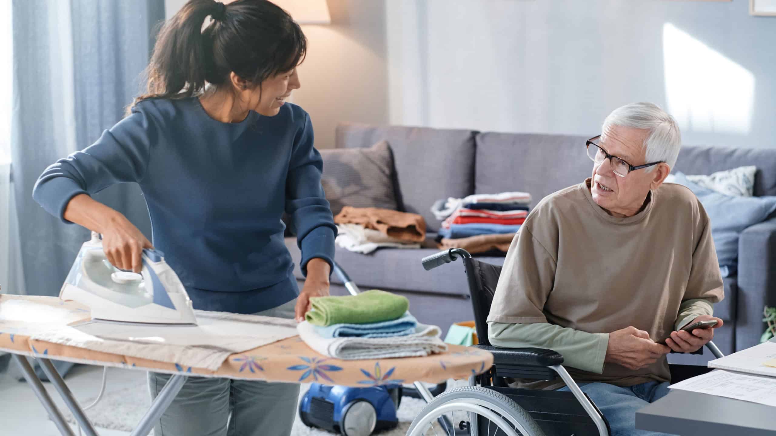 Volunteer helping to senior man with chores
