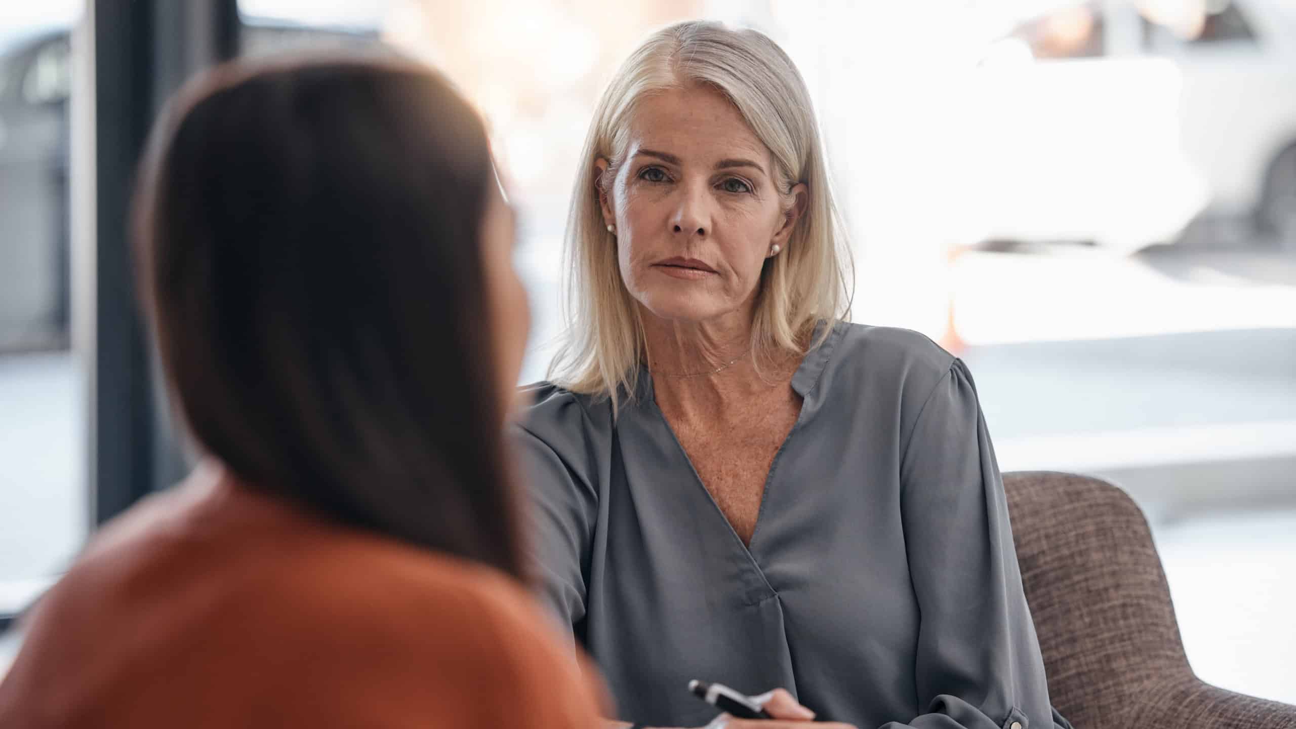 Listening, analysis and psychologist with a woman for therapy, consultation and anxiety support. Psychology, helping and therapist talking to a patient about depression during counseling meeting