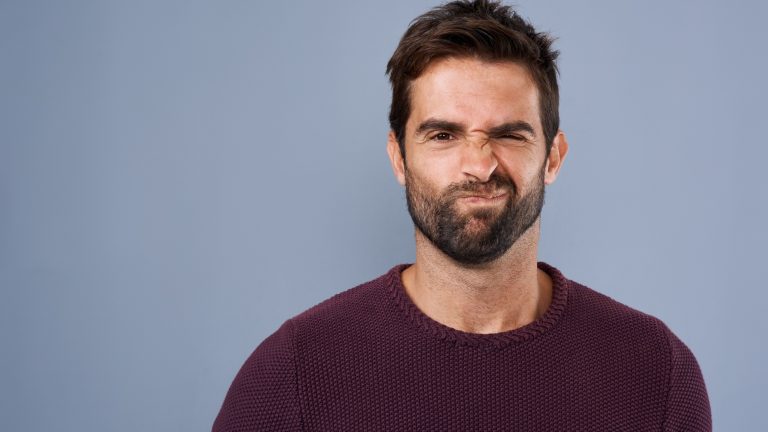 Doubt, unsure and portrait of man in studio with doubtful, uncertain and thoughtful on gray background. Thinking, mockup space and face of male person skeptical for decision, choice and question