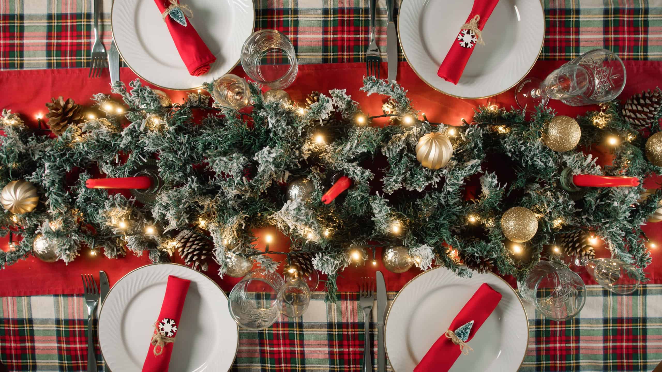 Family preparing the table set for Christmas dinner
