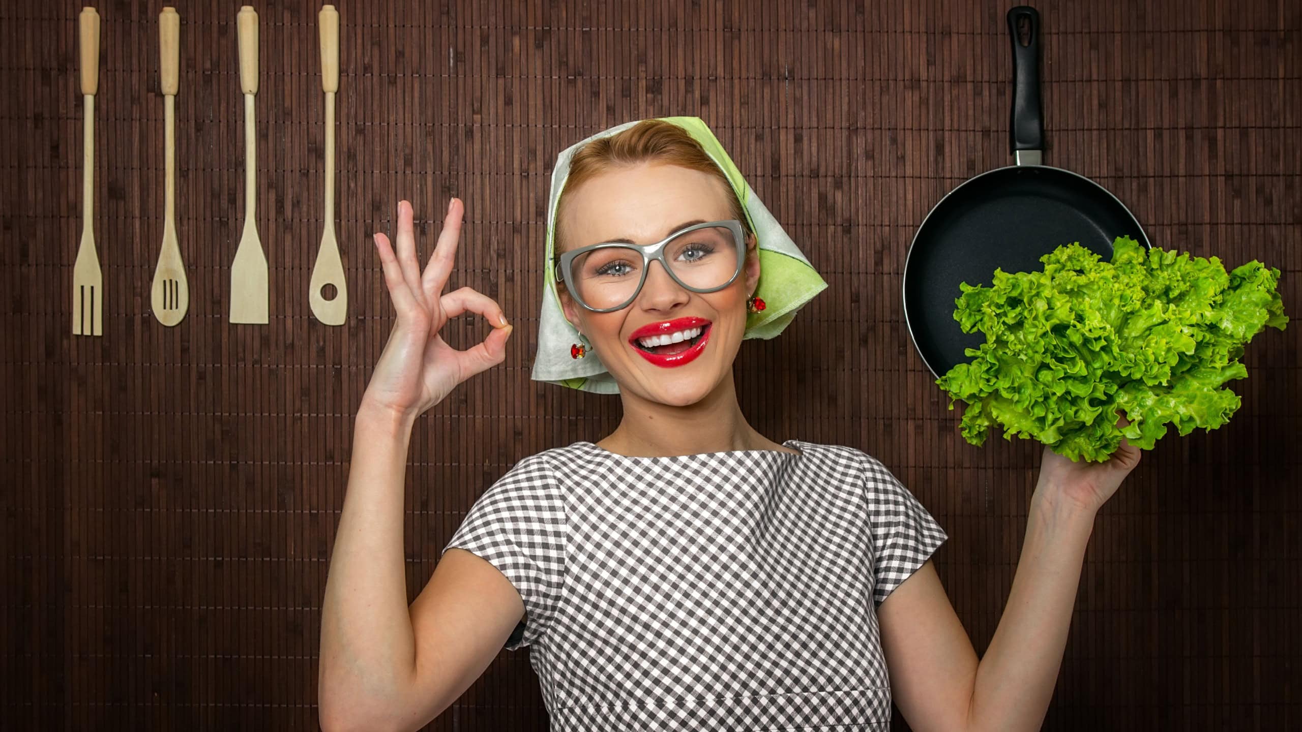 Happy woman cook with okay sign holding salad, close up