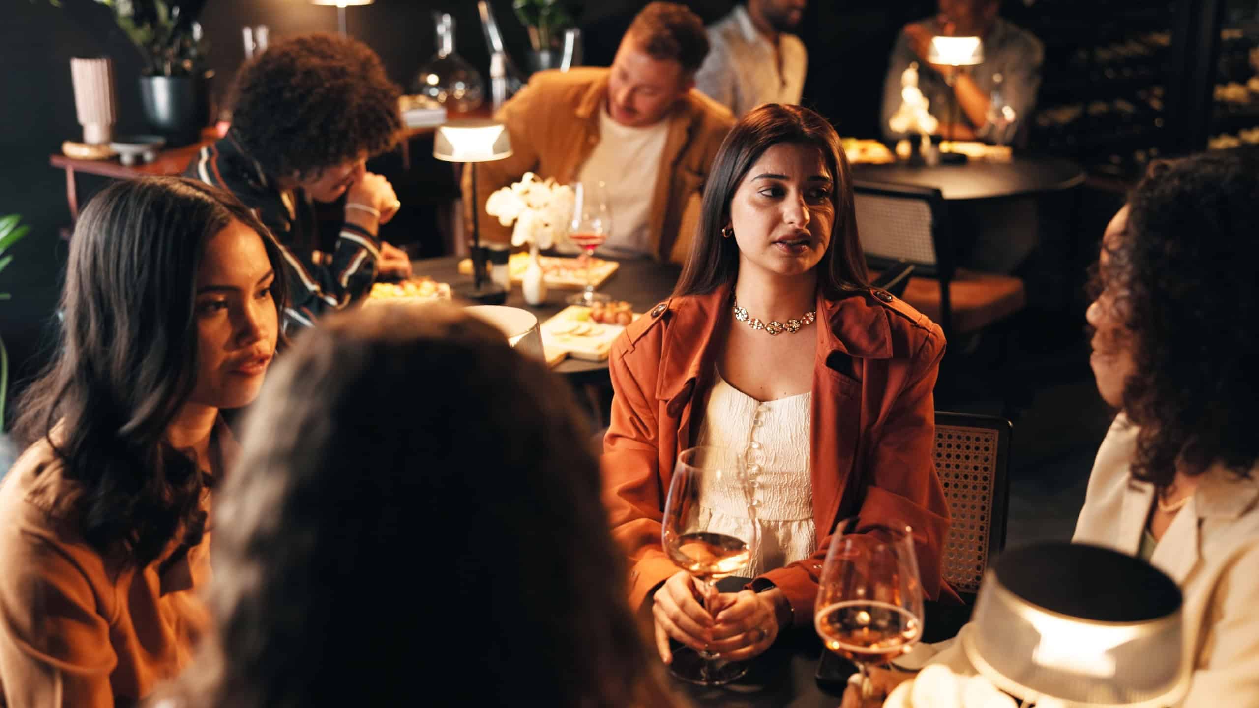 Relax, wine and talking with friends in restaurant for discussion, reunion and conversation. Fine dining, culture and gossip chat with women and drink for weekend, nightlife and social event
