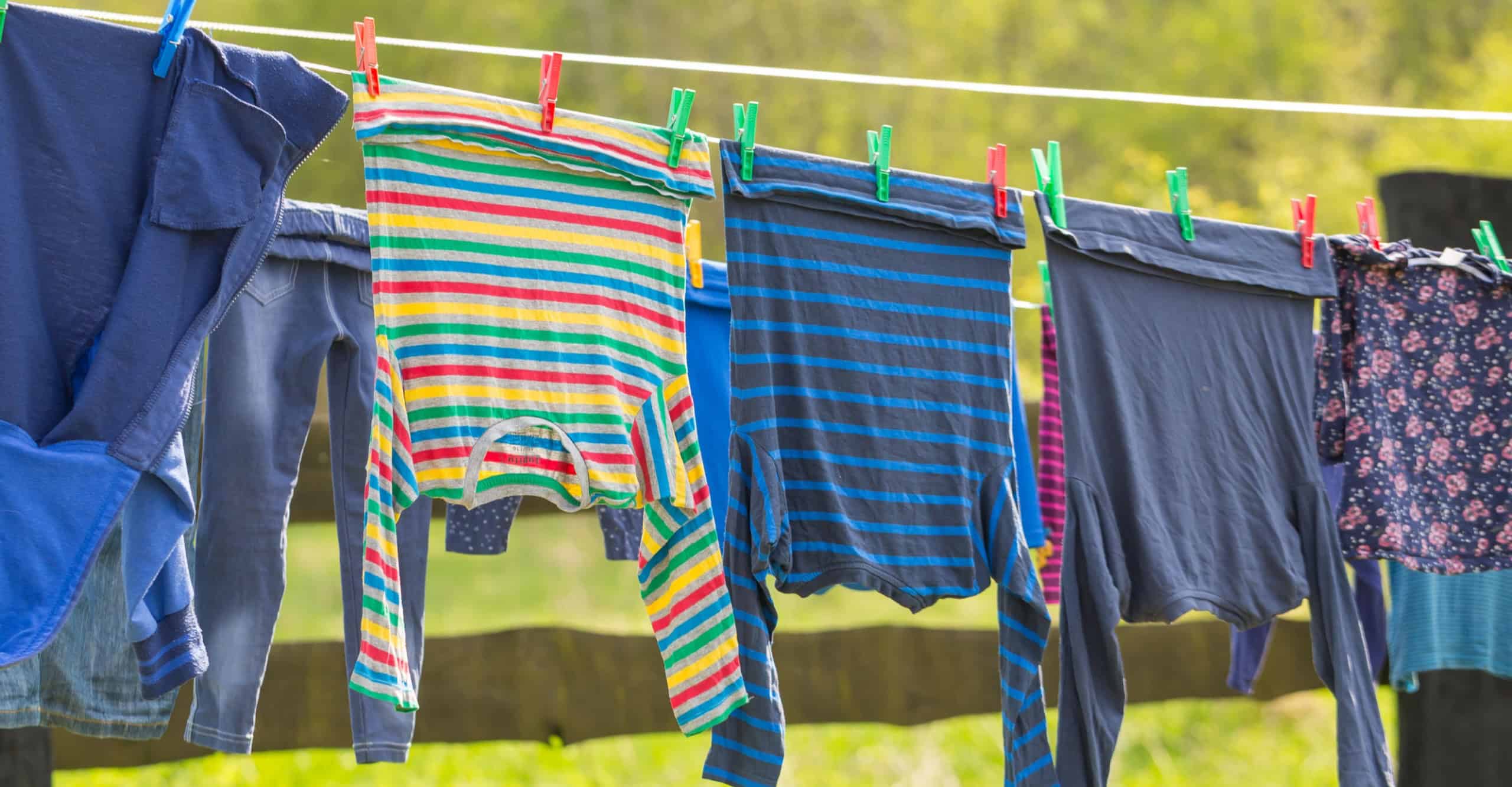 Washing line with drying clothes in outdoor. Clothes hanging on washing line in outdoor.