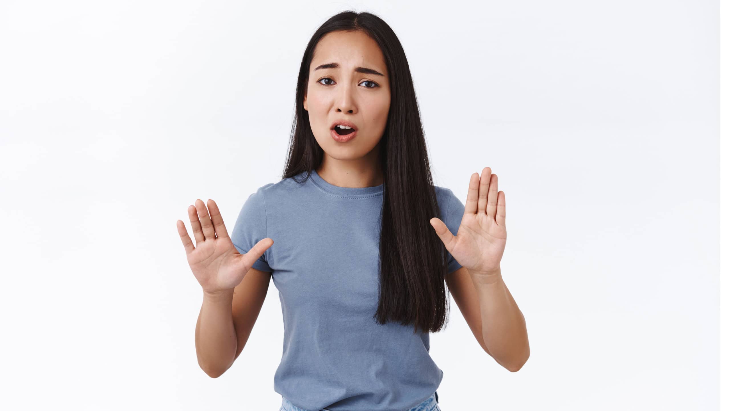 Girl asking to slow down or stop, pull your horses, raising arms up in prohibition, trying calm someone, telling its bad idea, standing nervous and doubtful, dislike plan, white background