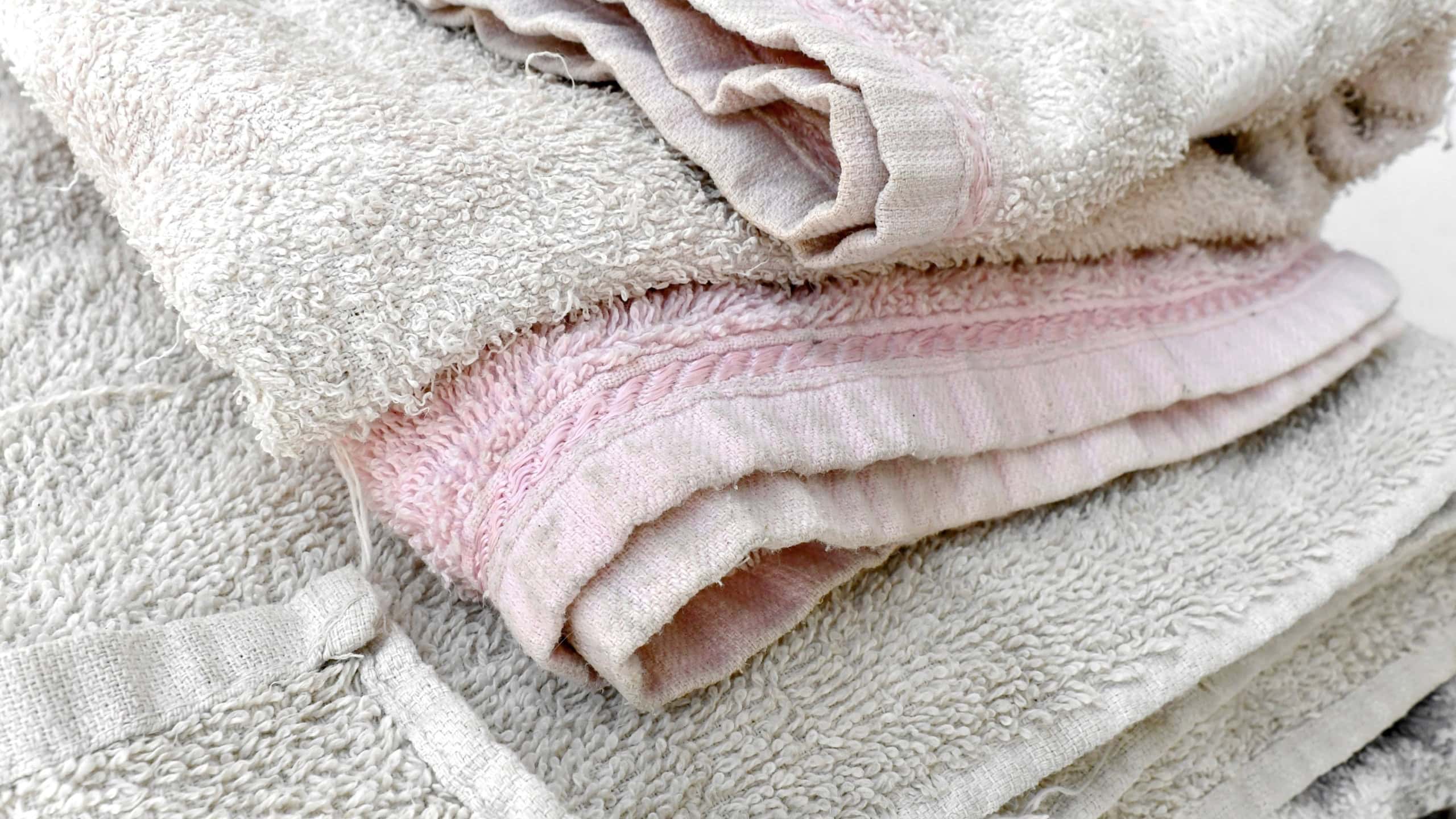 Old towel texture background. Pulled threads on towel. How to care for your bath towels concept.