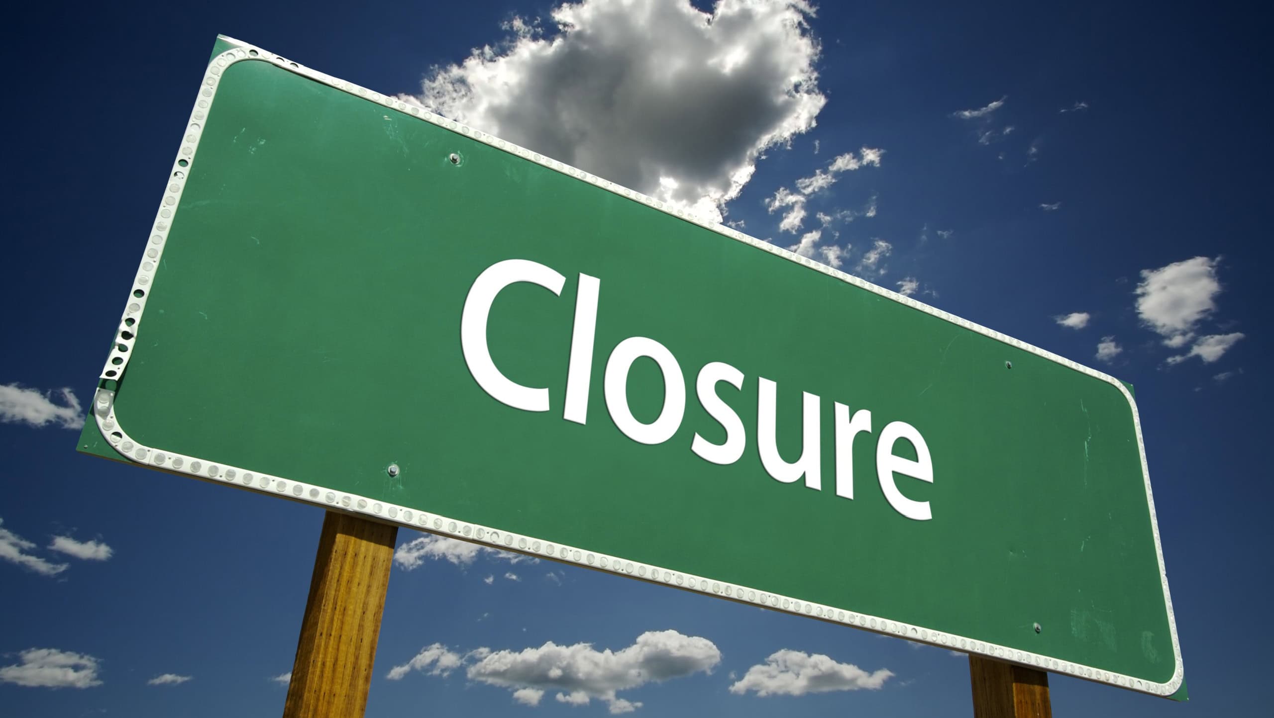 Closure Road Sign with dramatic clouds and sky.
