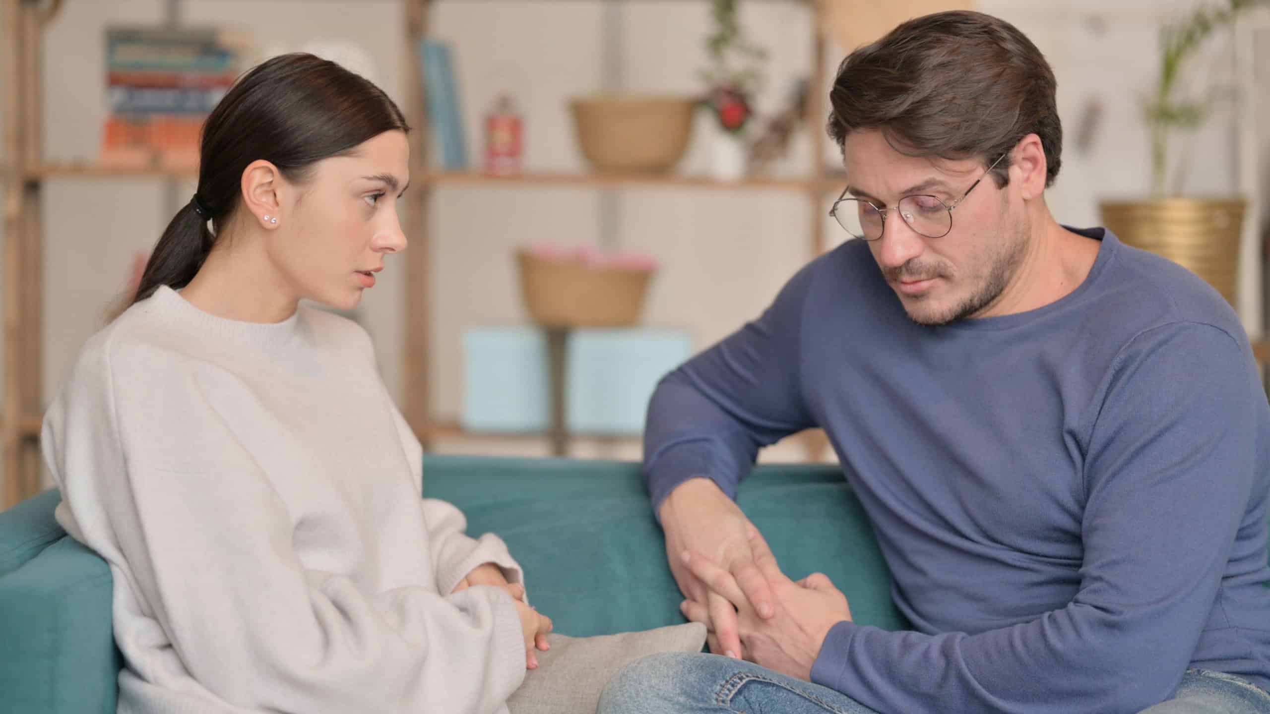 Tense Mixed Race Couple Sitting Upset at Home