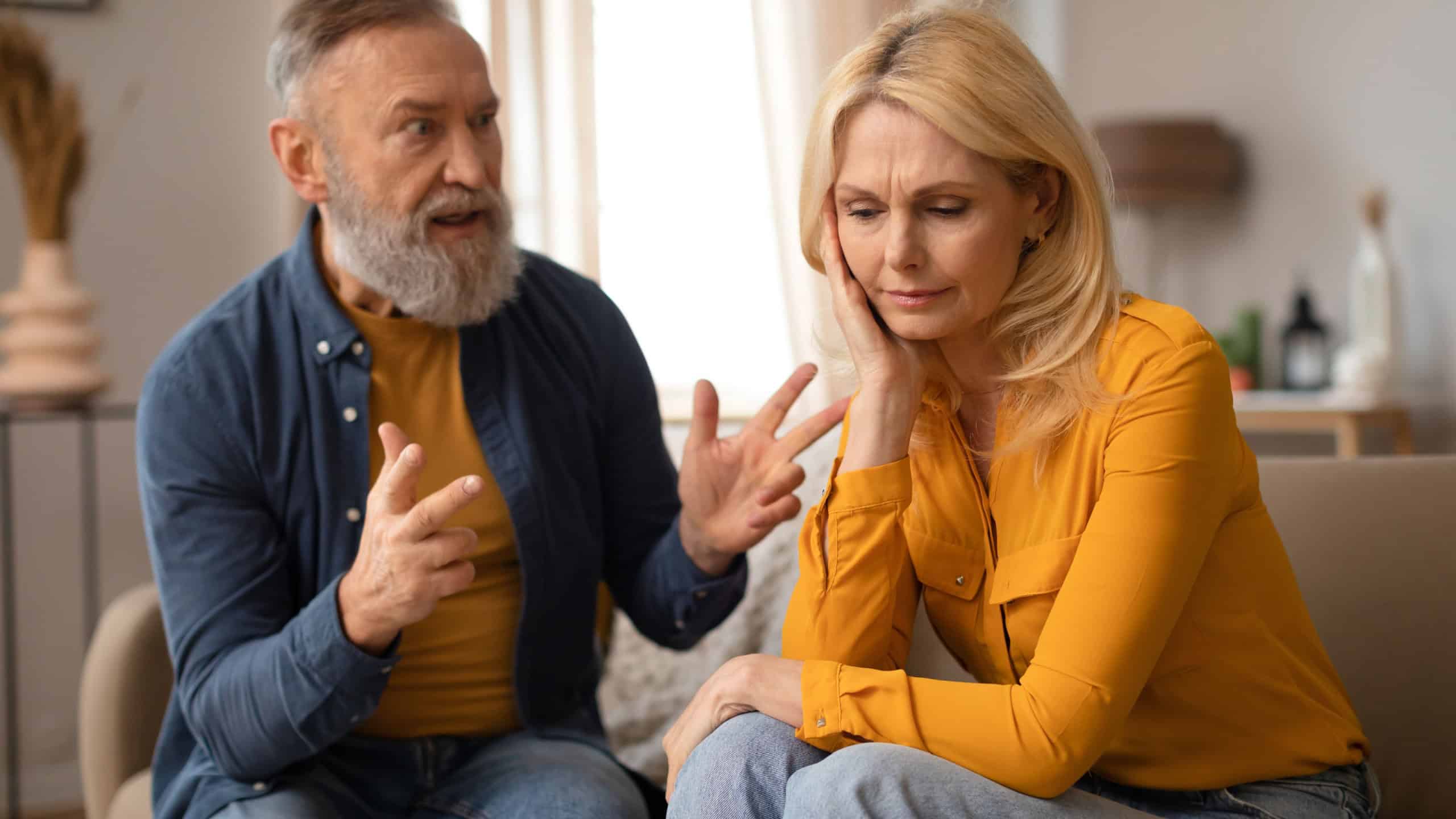 Unhappiness In Marriage. Senior Couple Having Quarrel, Husband Shouting At Upset Wife, Experiencing Tense Moments In Relationship Sitting At Home. Domestic Abuse And Conflicts. Selective Focus