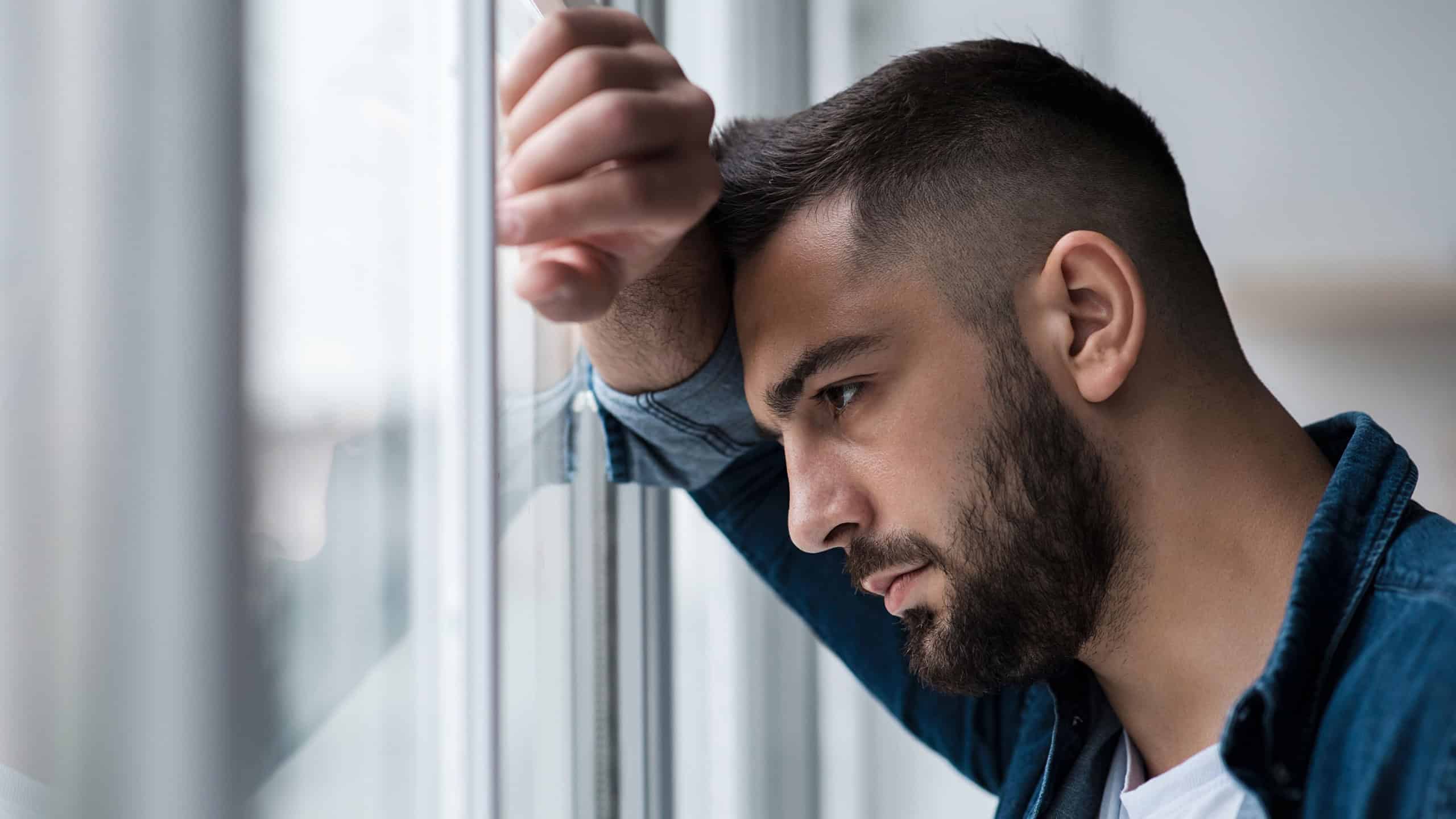 Depressed caucasian man losing job and heartbroken at same time alone, feeling bad and expresses negative