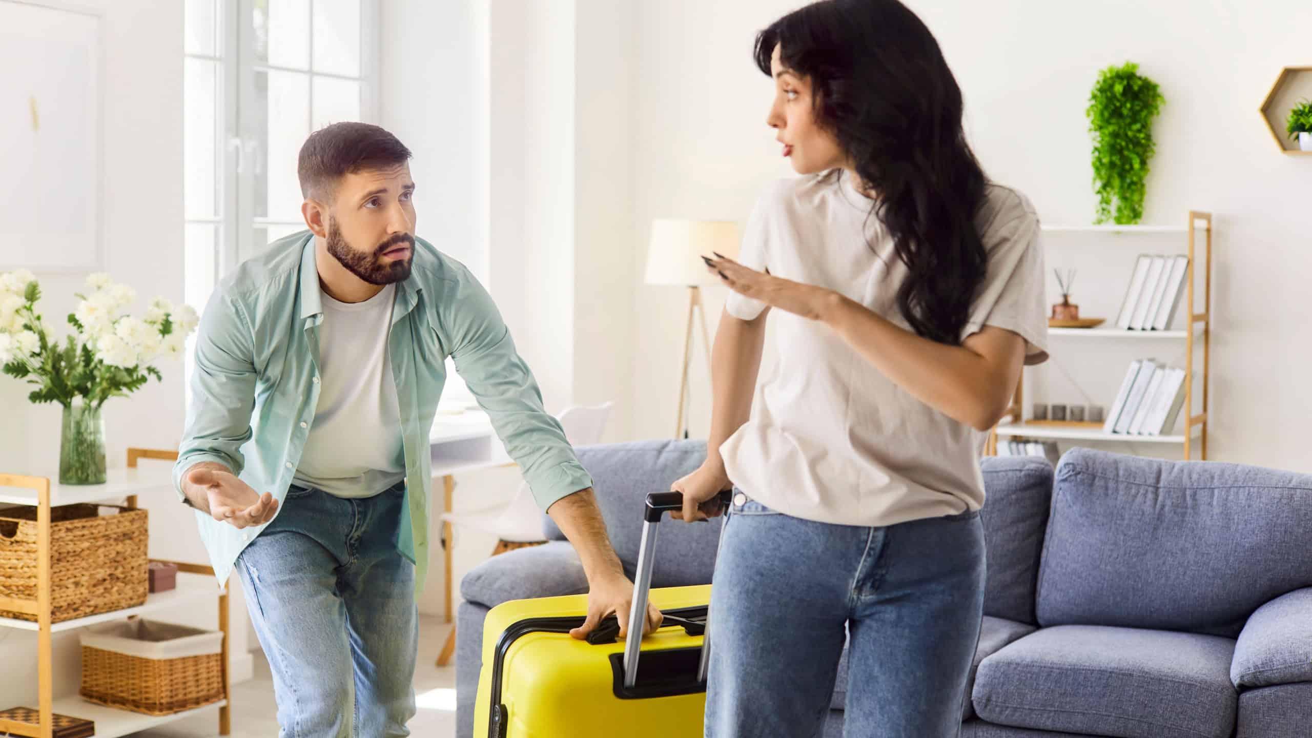 Couple conflict at home, wife refusal to husband request to forgive for cheating and betrayal. Guilty sad man pleading, girl leaving with suitcase and rejection gesture, ultimatum in conversation