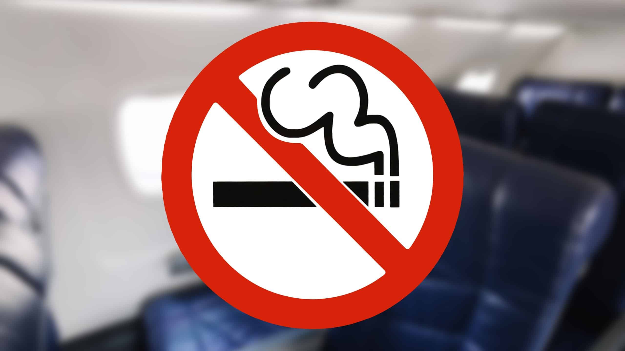No smoking sign inside airplane cabin. Passenger seats in aircraft interior. Flight safety regulation symbol. Smoking prohibition during travel. Airline rules and onboard safety awareness.