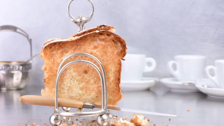 Sliced brown bread in silver antique rack toasted breakfast time in hotel