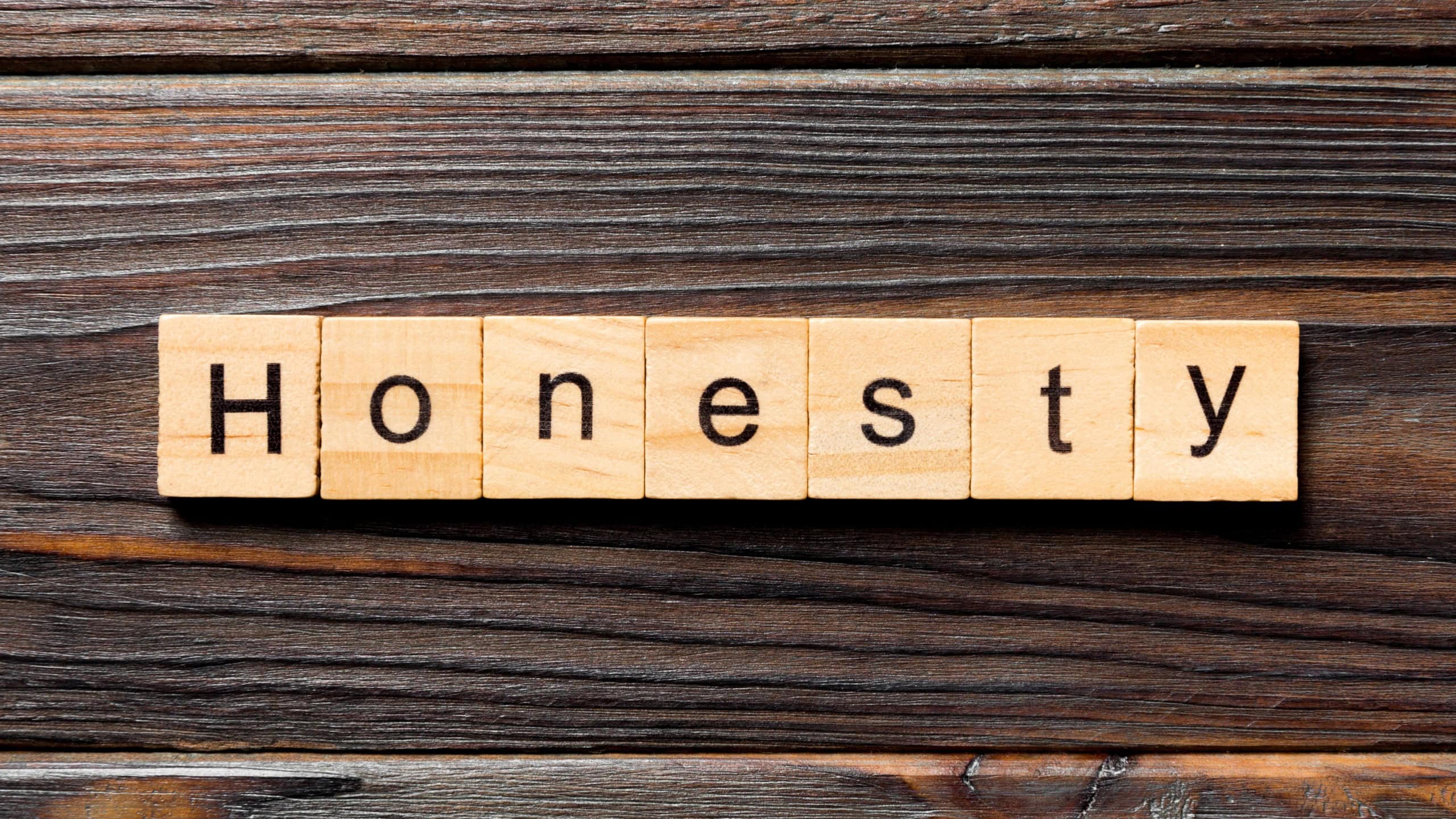honesty word written on wood block. honesty text on table, concept.