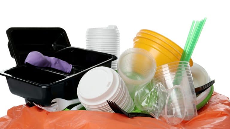 Pile of different plastic items on white background