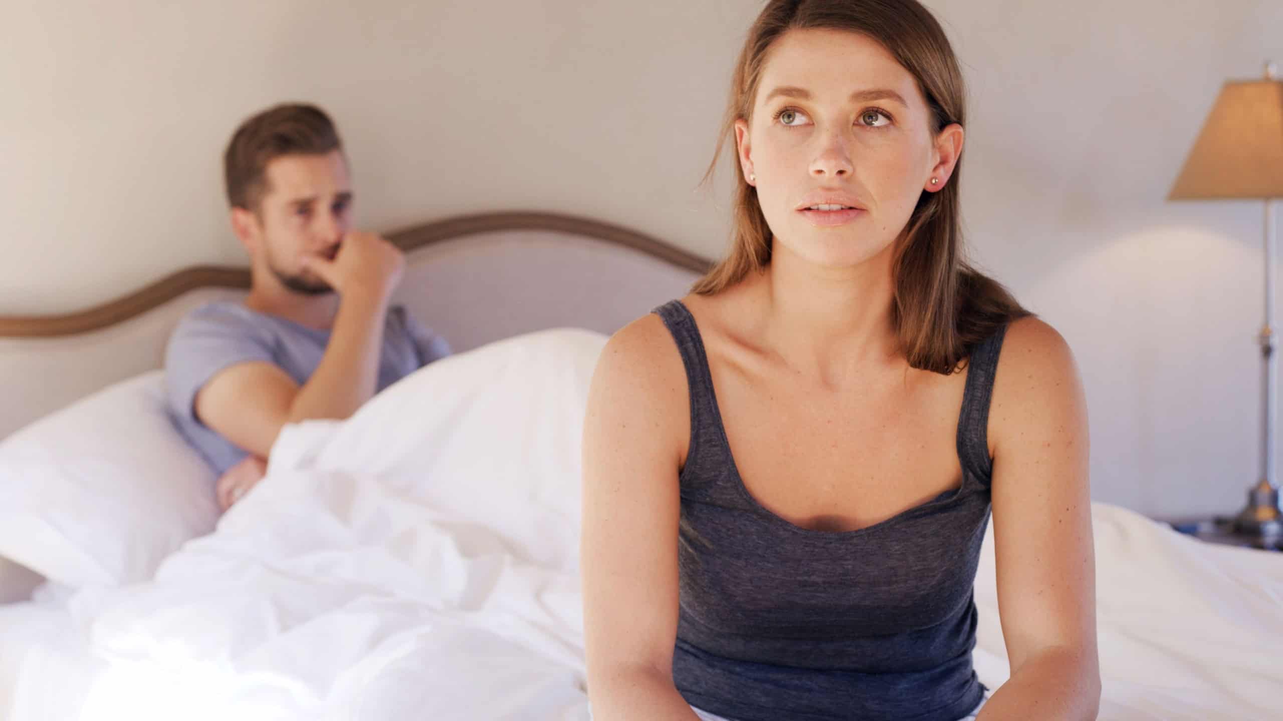 Upset, woman and couple in bedroom, breakup or thinking of betrayal, sad or marriage regret in home. Cheating, spouse and reflection for divorce, mental health and people in toxic relationship