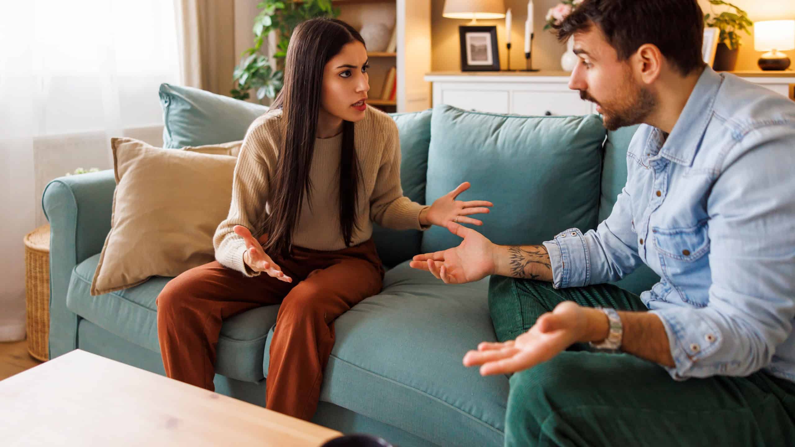 Young couple breaking up arguing at home, yelling at each other - marriage divorce or relationship break up concept