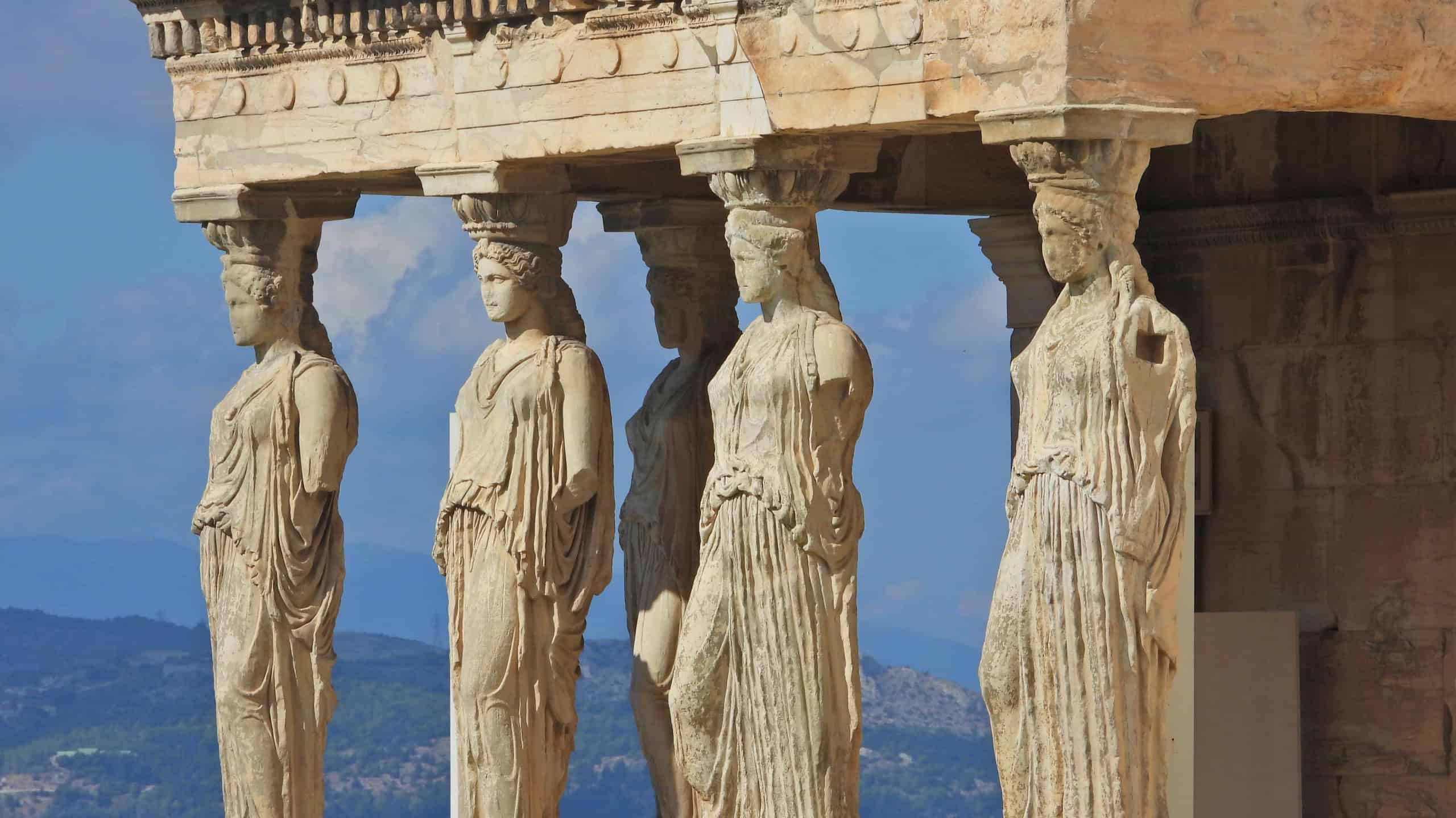 Extreme zoom closeup detail photo of iconic Caryatids statues in porch of Caryatids located on top of Acropolis hill next to iconic masterpiece Parthenon, Athens historic center, Attica, Greece