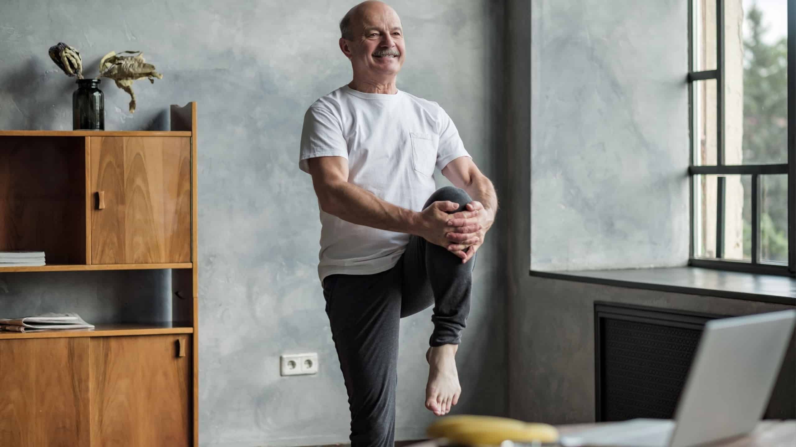 Senior hispanic man standing in one leg yoga balance. Healthy lifestyle at old age