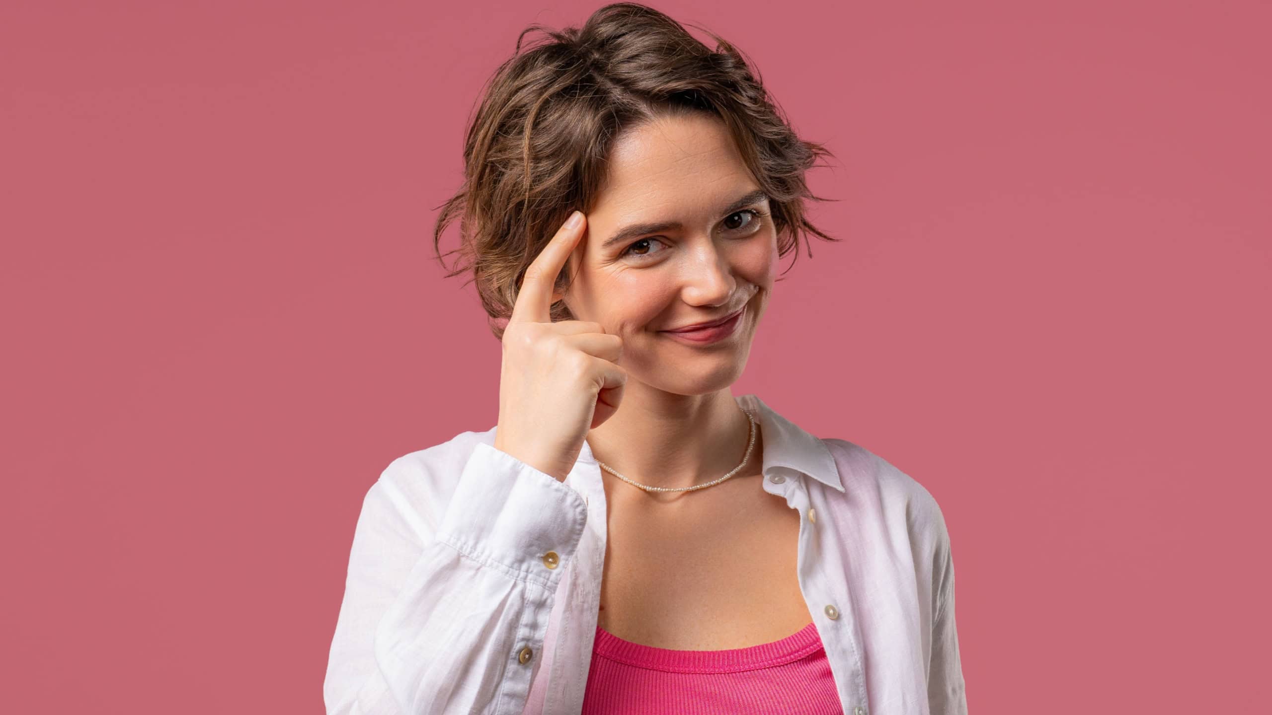 Pretty brainy woman with gesture - you, think about it. Looking camera on pink. Thinking positive. Intelligent person. High quality