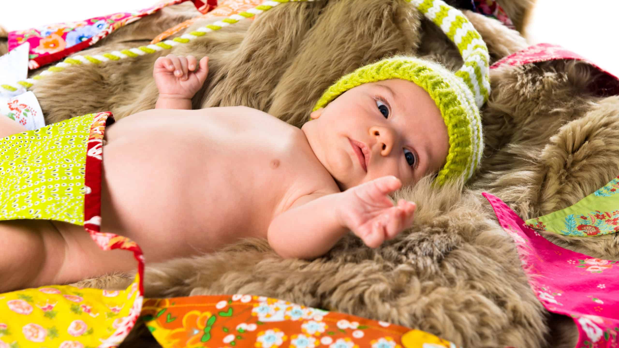 Cute newborn baby with a medieval cap