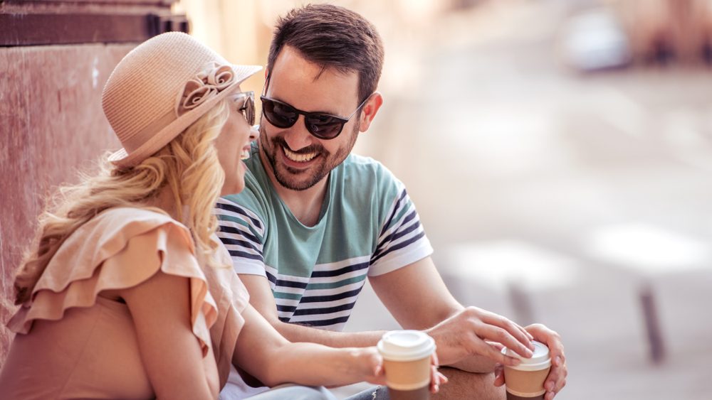 Happy young couple having fun and laughing together outdoors.Holidays,people,vacation, love and travel concept.