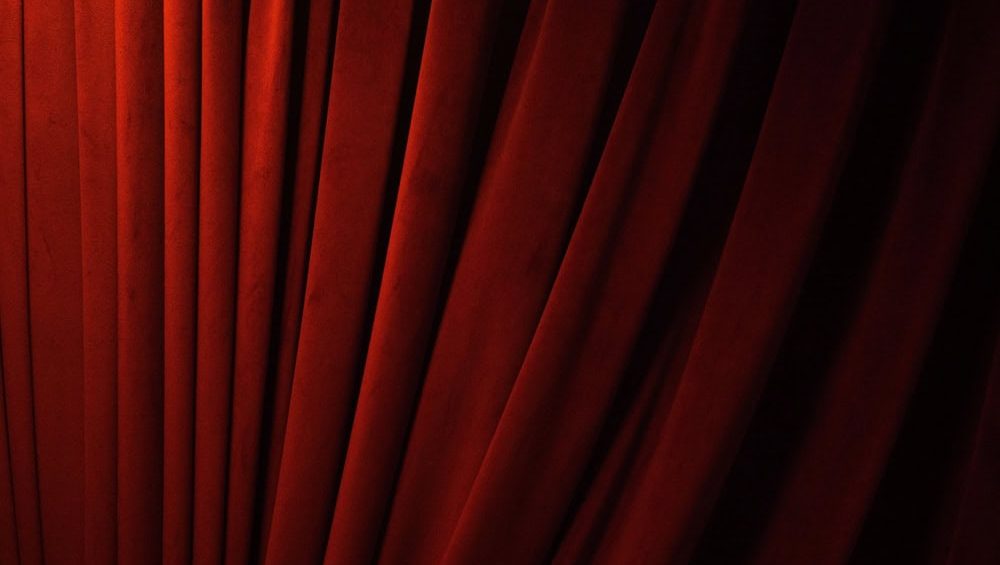 Red pink orange color gradient background wallpaper curtain waving vulvet stage theatre entertainment presentation opera art drape concert ceremony cinema show textile film cloth front dark advertise