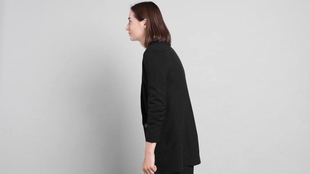 Woman,With,Poor,Posture,On,Gray,Background