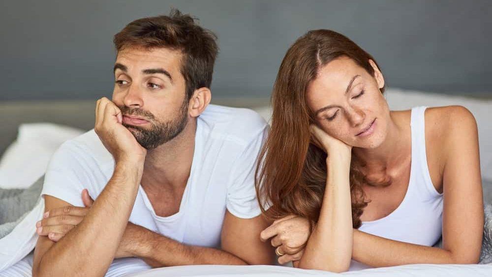 Bedroom, bored and ignore with couple, divorce and home with argument, emotion and separate. People, tension or man with woman, dispute and crisis with marriage, conflict or stress with relationship
