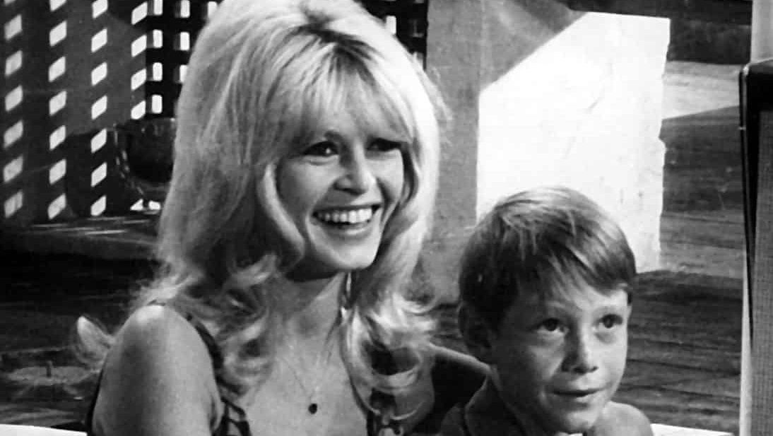 Publicity photo of Brigitte Bardot and Billy Mumy on set of Dear Brigitte (1965).
