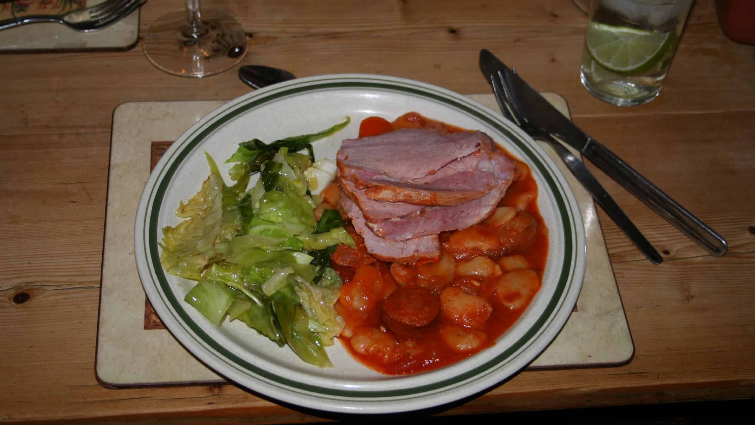 Ham braised with butter beans in tomato sauce. Boiled spuds if people wanted them, braised Sweetheart cabbage on the side