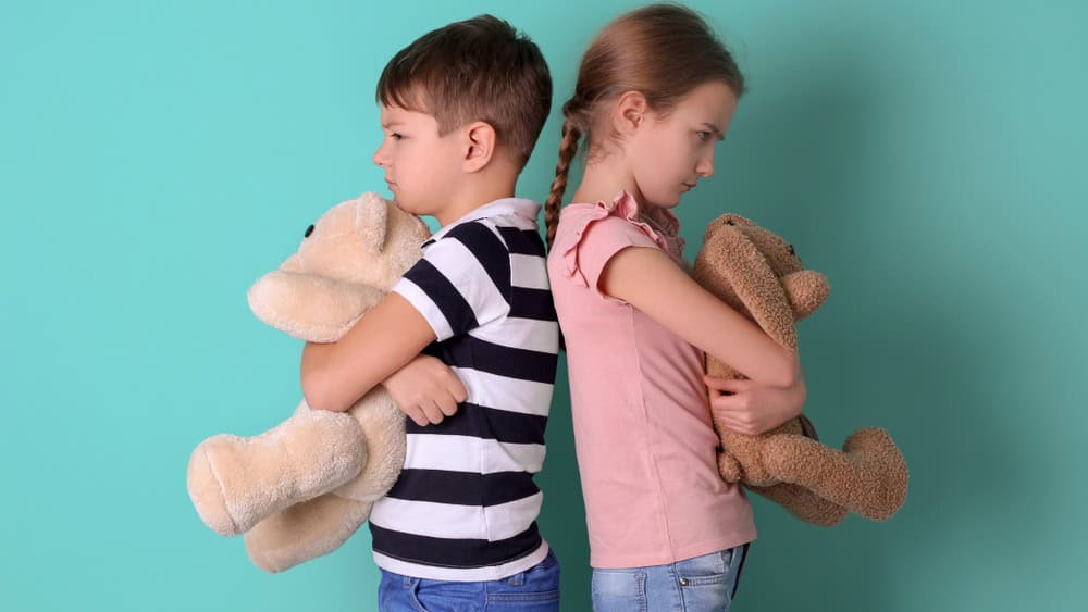 Brother arguing with sister on color background