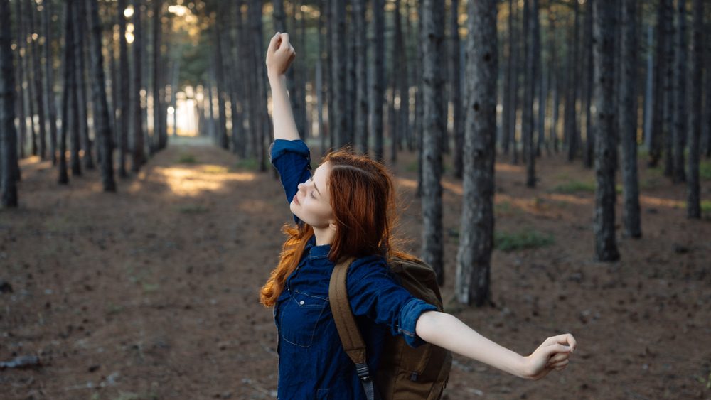 happy woman in forest nature