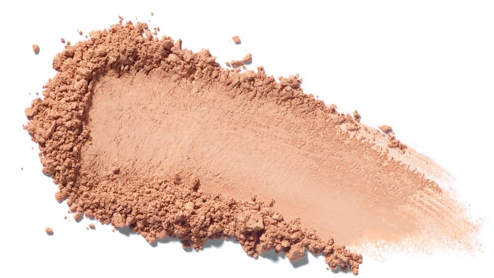 close up of face powder on white background