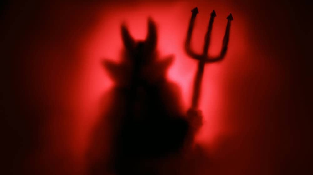 Creepy Devil silhouette from hell in the mist with backlit.