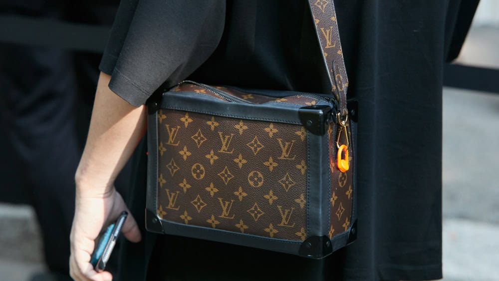 MILAN, ITALY - JUNE 17, 2019: Woman with brown Louis Vuitton bag before Fendi fashion show, Milan Fashion Week street style
