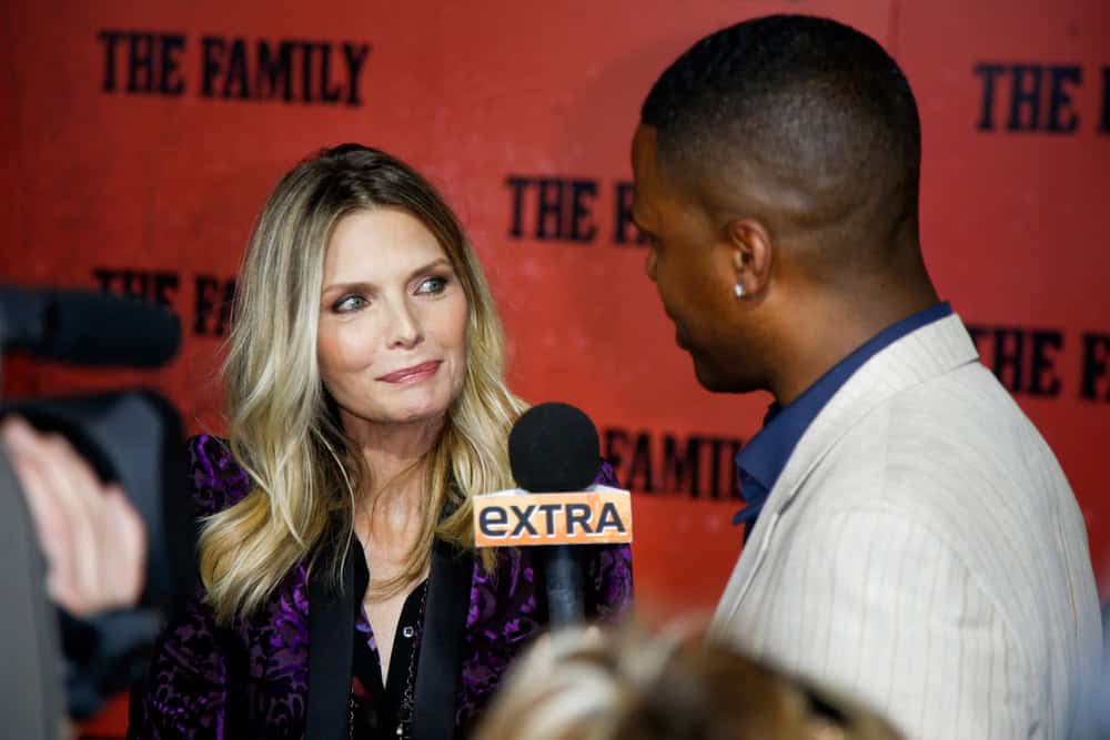 NEW YORK-SEP 10: Michelle Pfeiffer speaks with A.J. Calloway at "The Family" world premiere at AMC Lincoln Square Theater on September 10, 2013 in New York City.