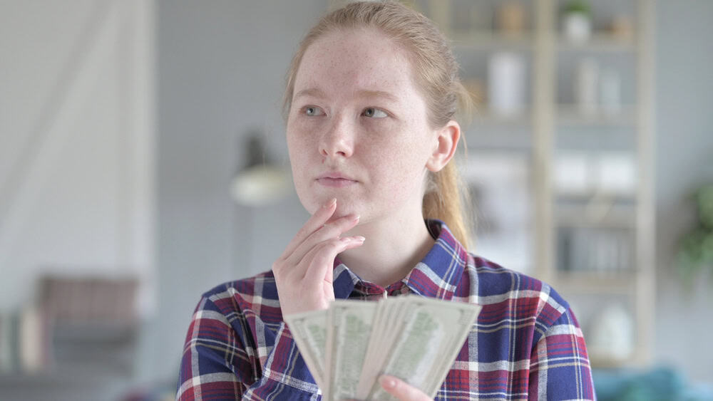 The Serious Young Woman Counting money