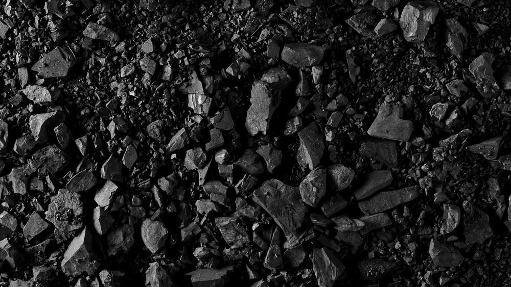 Pile black coal isolated on black background and texture, clipping path and top view