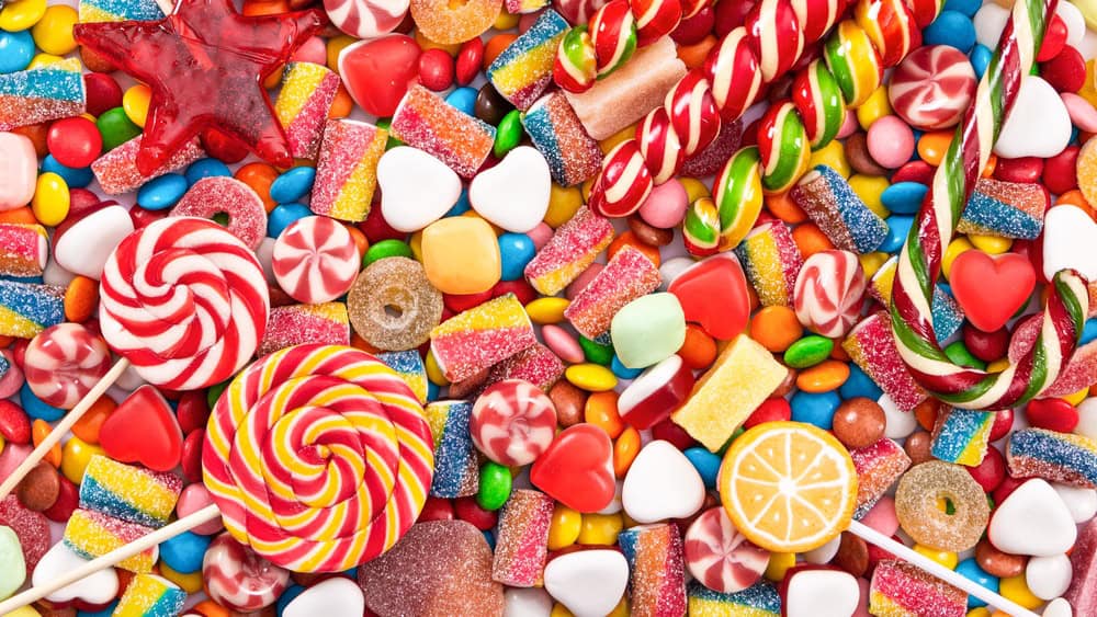 Colorful lollipops and different colored round candy. Top view.