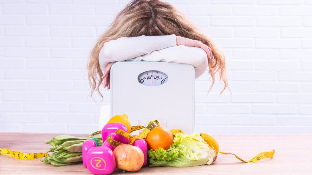 depressed and stressed woman unable to control diet to lose weight