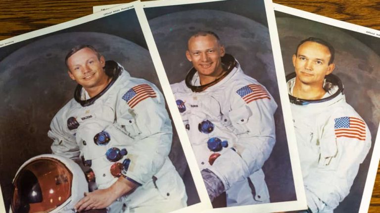Jefferson City, Missouri - May 31, 2023: Portraits of the Apollo 11 moon landing mission on a desk in an office.
