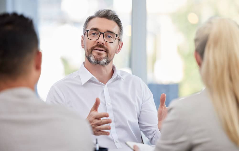 Business meeting, advice and man, accountant or manager b2b planning, client talking or finance consulting. Helping, support or advice of financial advisor, accounting ceo or senior person interview