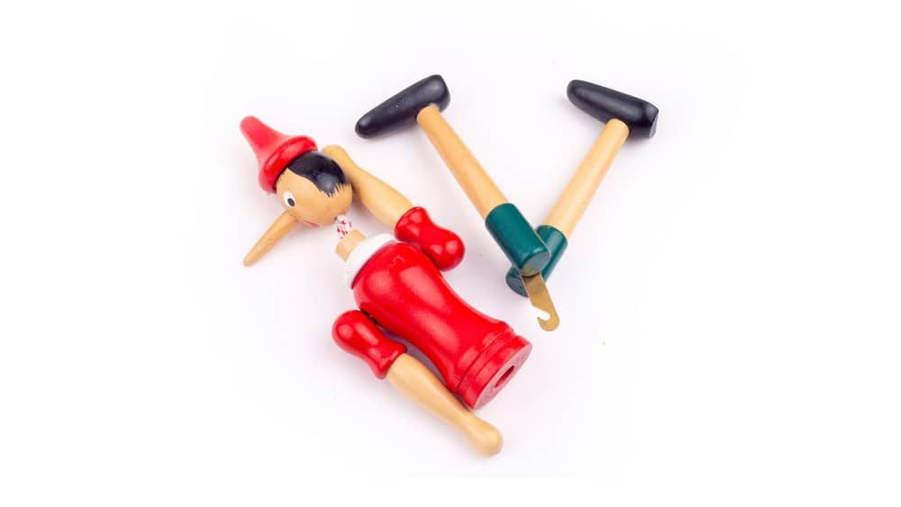 Toy Puppet Broken Pinocchio on White Background