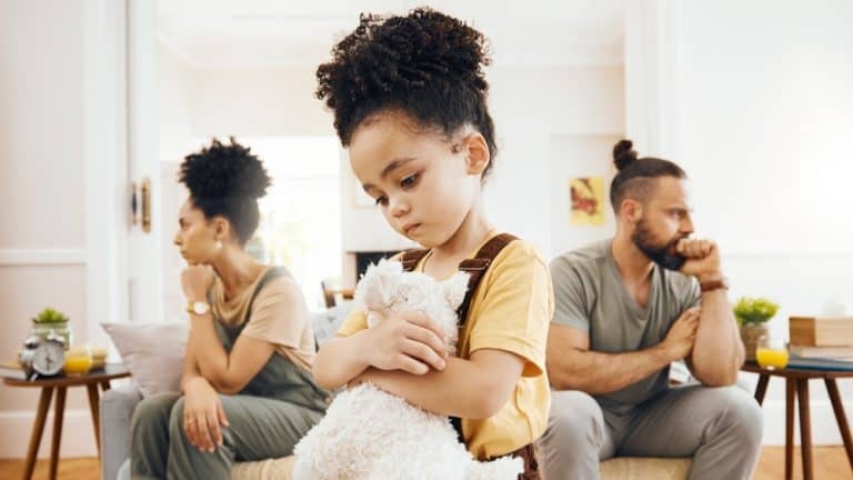 Divorce, custody and sad boy child with teddy bear in living room for stress, support and comfort at home. Family, crisis and kid with anxiety for toxic parents, argue or dispute, depression or fear