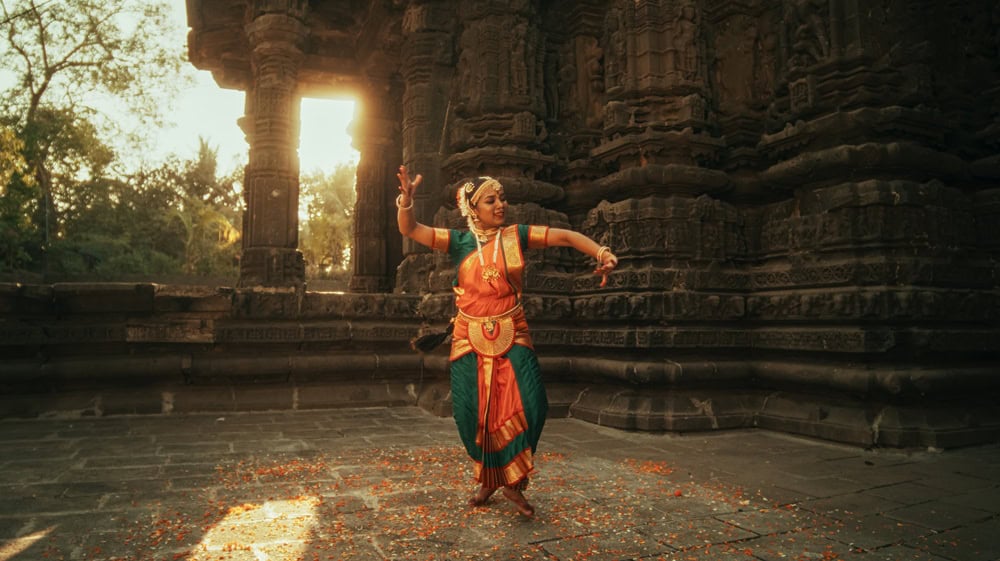 Dramatic Performance Done by an Indian Girl Practicing the Art of Bharatanatyam in an Ancient Temple. Expressive Young Female in Colourful Traditional Sari Dancing Folk Dance Choreography