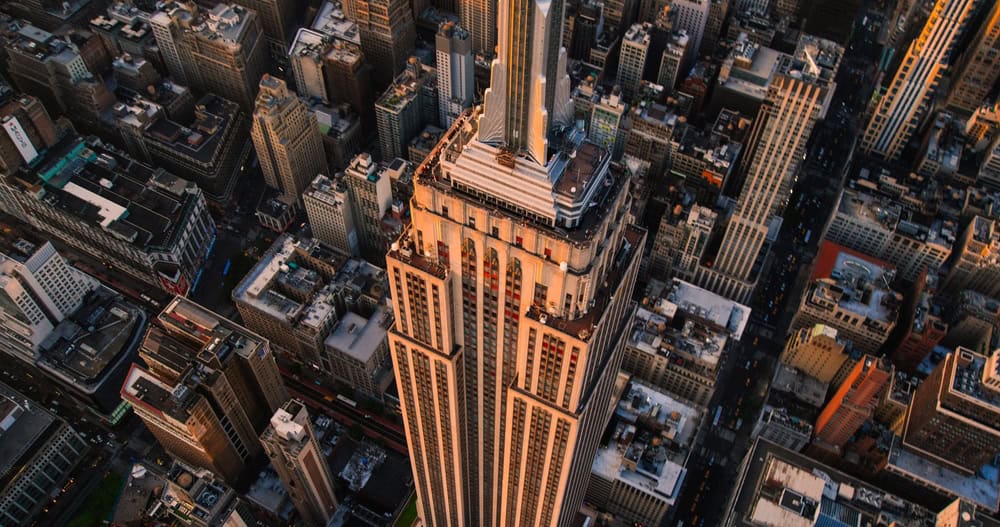 EDITORIAL: NEW YORK CITY, THE UNITED STATES OF AMERICA - MAY 15 2023: Aerial View of Empire State Building Spire and a Top Deck Tourist Observatory. Helicopter Shot of an Architectural Wonder